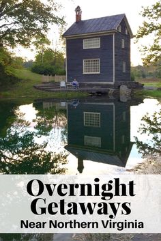 a blue house with the words overnight getaways near it in front of water