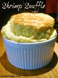 a bowl filled with mashed potatoes sitting on top of a wooden table