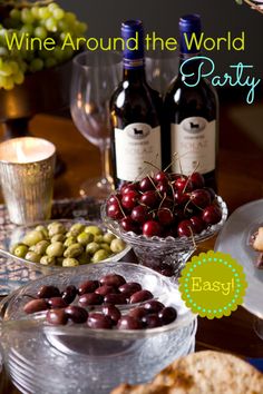 a table topped with wine bottles and plates filled with food next to glasses of wine