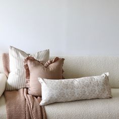 the pillows on the couch are all different colors and patterns, but one is white