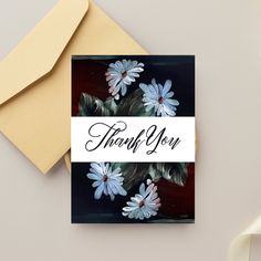 there is a card with flowers on it and the words thank you written in black