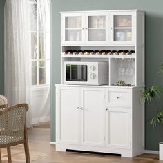 a white microwave oven sitting on top of a cabinet