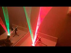 two people are walking through a room with colored lights