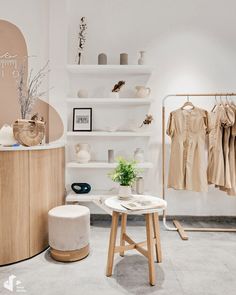 a clothing store with white walls and shelves