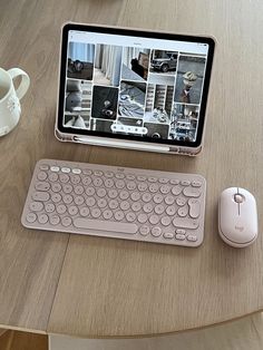 a tablet computer sitting on top of a wooden table next to a keyboard and mouse