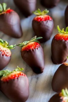 chocolate covered strawberries are arranged on a table