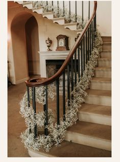 an elegant staircase decorated with baby's breath flowers