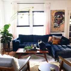 a living room filled with furniture and a cat sitting on top of a coffee table