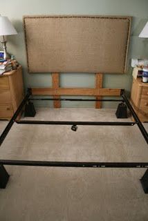 a bed frame with two lamps on each side