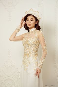 Elegance and grace take center stage with our Jiayi White Vietnamese Ao Dai, a timeless and enchanting choice for your special day. With an illusion neckline and back, this gown creates an ethereal and captivating aura. Long sleeves add a touch of classic beauty creating a sophisticated look. The exquisite couture lace adorns the entire ensemble, adding a luxurious and intricate touch. Embrace tradition and elegance in our Ao Dai, a gown that will make you feel like a vision of beauty on your wedding day Detail: White Vietnamese Ao Dai Collar: 1.4in/ 3.5cm Illusion neckline Illusion back Long sleeves Bra cups added Zipper closure White chiffon pants Sweep train (12''/30cm) Couture lace Made to order White Ao Dai Wedding Dress, Fitted Lace Back Gown For Debutante Ball, Fitted Gown With Illusion Neckline For Debutante Ball, Wedding Evening Dress With Sheer Back And Fitted Bodice, Wedding Gown With Sheer Back And Fitted Bodice, Gold Wedding Dress With Sheer Bodice, Ceremony Dress With Sheer Fitted Bodice, Fitted Dress With Sheer Bodice For Ceremony, Fitted Sheer Bodice Dress For Ceremony