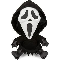 a black and white stuffed animal wearing a ghost costume