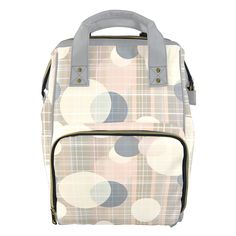 a white and grey bag with circles on it's front pocket, zippered closures