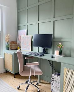 a desk with a computer on top of it in front of a window next to a radiator