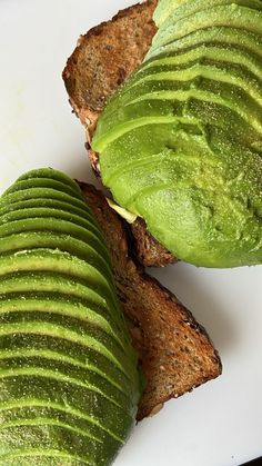 two pieces of bread with avocado on them