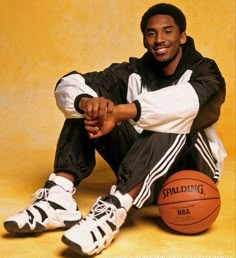 a man sitting on the ground with a basketball