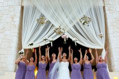 the bride and her bridal party are raising their hands