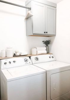 a white washer and dryer sitting next to each other in a laundry room