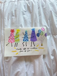 a handmade birthday card with three girls holding balloons and saying, happy off to another year of your life