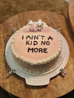 a birthday cake with the words i am not a kid no more on it sitting on top of a wooden table