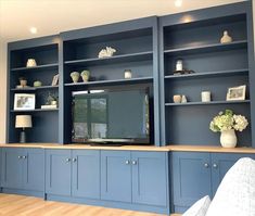 an entertainment center with blue cabinets and shelves