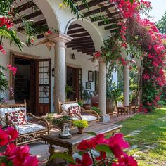 an outdoor patio with furniture and flowers on it