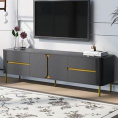 an entertainment center with a flat screen tv mounted on the wall and yellow trimmings