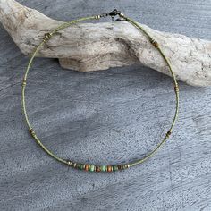 ✦Delicate and eye catching light olive green choker style single strand necklace with beige and turquoise green feature beads at center, I have added brass spacer beads to enhance the necklace. At back of the necklace I have used tiny 2mm seed beads I have created this piece with inspiration from tribal cultures around the world, while adding a modern  unique feel. ✦Size beads 4x4mm, 3x3mm 2x2mm. ✦Length of short strand 40.5cm (16") fitted with a lobster clasp and 45mm extension chain. ✦This nec Bohemian Single Strand Choker As A Gift, Green Bohemian Beaded Choker Necklace, Bohemian Green Beaded Choker Necklace, Bohemian Green Choker With Colorful Beads, Handmade Green Bohemian Choker, Green Tiny Beads Necklace For Festival, Adjustable Green Choker With Tiny Beads, Adjustable Green Choker Necklace, Bohemian Adjustable Single Strand Choker