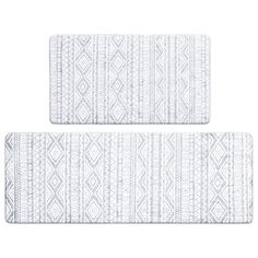 two white bath mats with an intricate pattern on the front and back of each one