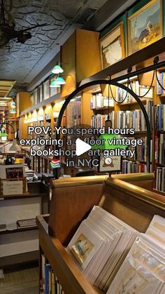 the inside of a book store with lots of books on shelves and pictures hanging from the ceiling