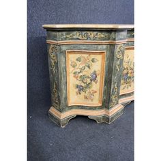 an ornate painted cabinet with flowers on it