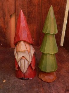 two wooden gnomes sitting next to each other