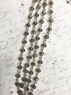 "Listing is for 1 Meter Chain ( 1 meter is: 3Ft + 3.5\" Feet of Chain 39\" total) 6mm x 4mm gray Rondelle glass beads Silver tone linked chain Great for the LONG BOHEMIAN NECKLACES FANTASTIC CHAIN Please keep in mind your monitor may show a variance in the actual color." Bead Rosary, Bohemian Necklace, Chain Silver, Faceted Bead, Beaded Chain, Silver Wire, Rosary, Silver Chain, Necklace Etsy