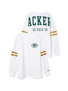 two green bay packers white long sleeve t - shirts with gold lettering on the sleeves