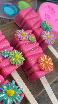 popsicles with flowers on them sitting on a table