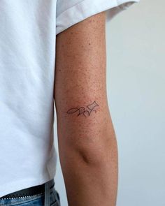 a person with a small tattoo on their arm