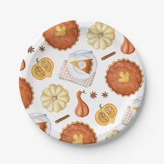 a white plate topped with lots of different types of pumpkins and other autumn items