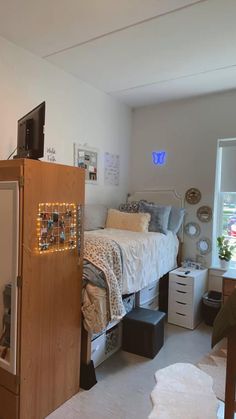 a bedroom with a bed, dresser and television