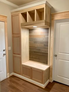 an empty room with wooden shelves and doors