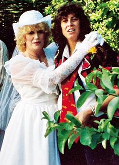 two women dressed in costumes posing for the camera