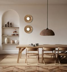 a dining room table and chairs in front of shelves with vases on the wall