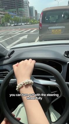 a woman driving a car with her hand on the steering wheel and text that reads, you can turn out with the steering wheel