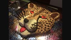 a cake shaped like a cheetah with red eyes