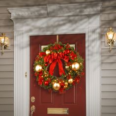 a christmas wreath on the front door of a house