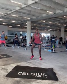 a group of people in a gym with one person jumping up and the other running