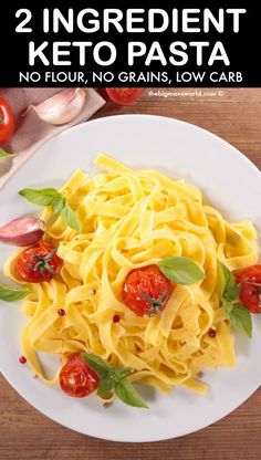 a white plate topped with pasta and tomatoes