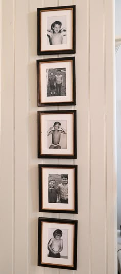 black and white photos hanging on the wall