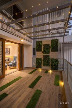 an indoor living area with grass and lights