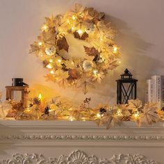 a mantle with a wreath and candles on it