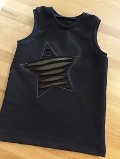 a black tank top with an embroidered star on it