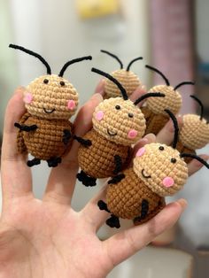 small crocheted animals are held in the palm of a person's hand